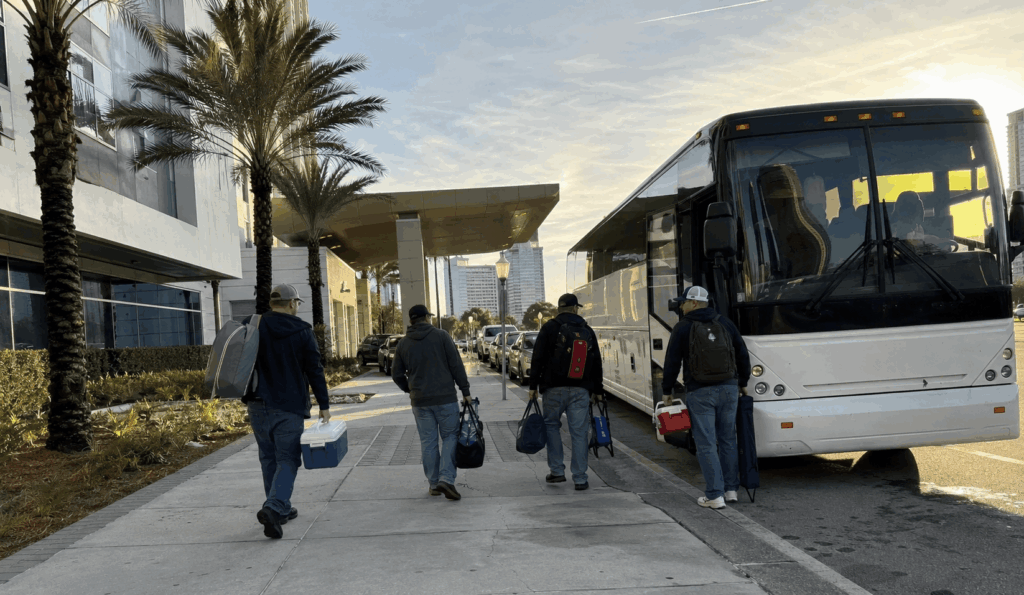 charter bus dropping off a small group of race fans near daytona international speedway before the daytona 500