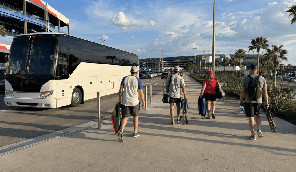 race fans arriving by charter bus near daytona international speedway before the coke zero sugar 400 night race