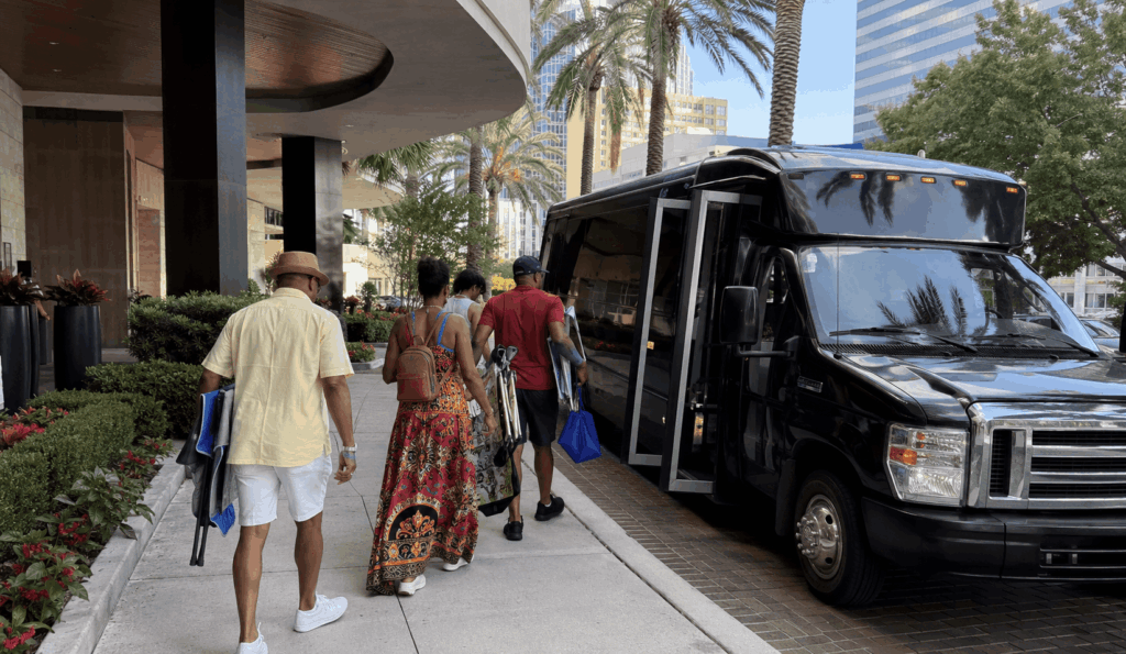 festival guests boarding a charter bus outside a downtown jacksonville hotel before heading to jazz fest