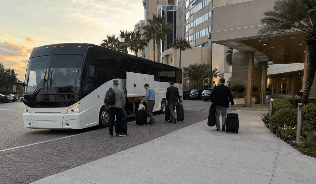 group boarding a charter bus in jacksonville for a long-distance airport transfer to orlando mco