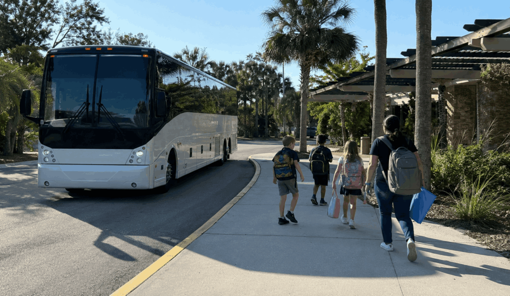 elementary school students and chaperones arriving by charter bus for a field trip at jacksonville zoo and gardens
