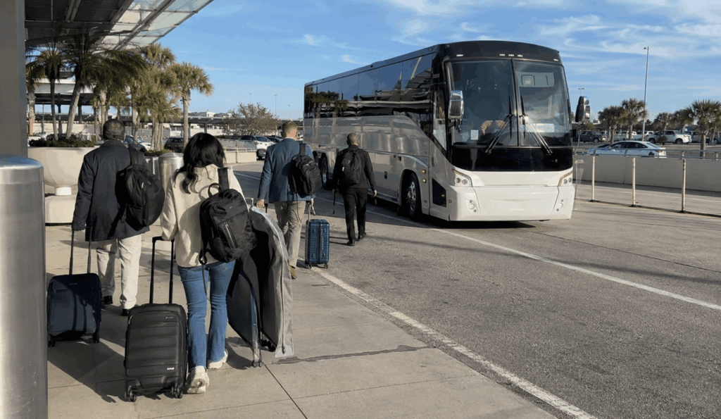 charter bus picking up group travelers near jacksonville international airport for a private jax airport shuttle