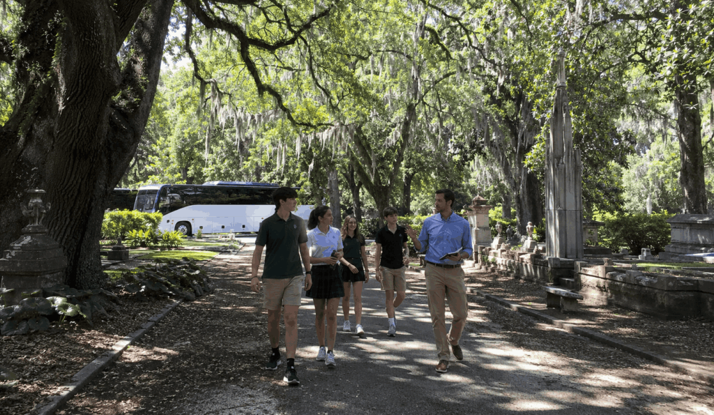 students walking through one of savannah's historic squares during a school history field trip